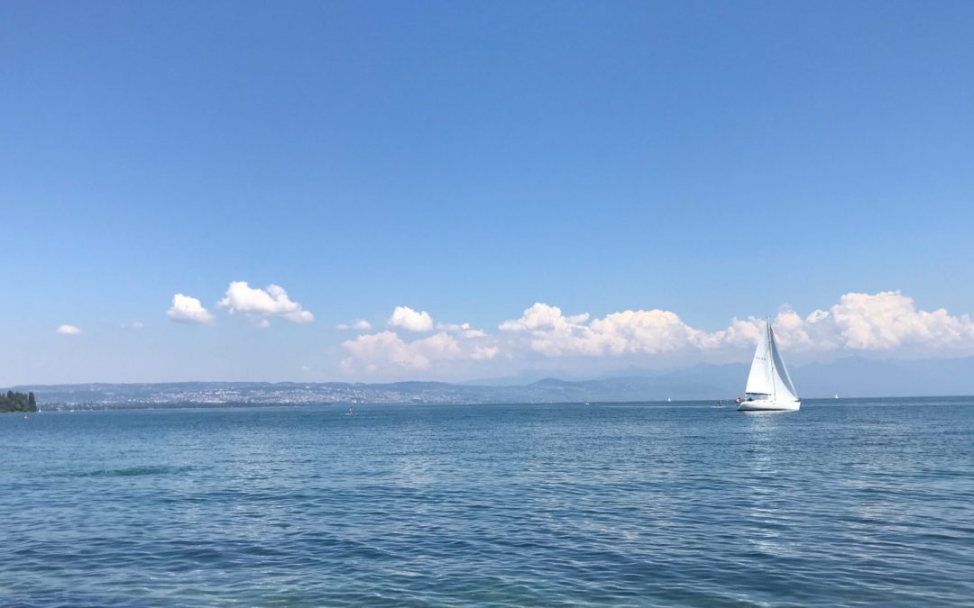 A sailing boat with wind in the sails moving forward
